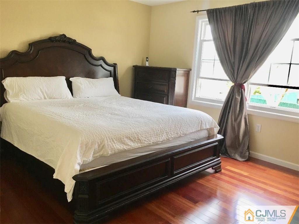 23 Raleigh Road Edison, NJ 08817 - Photo 12 of 19 a bedroom with a bed and a window