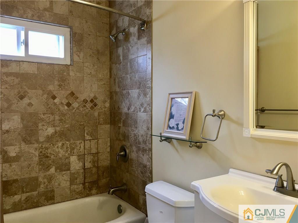 23 Raleigh Road Edison, NJ 08817 - Photo 16 of 19 a bathroom with a sink a toilet and shower