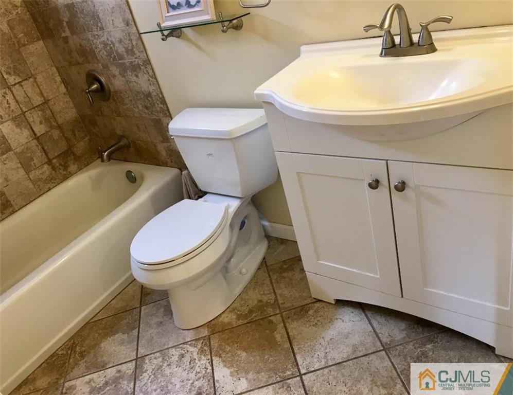 23 Raleigh Road Edison, NJ 08817 - Photo 17 of 19 a bathroom with a toilet and a sink