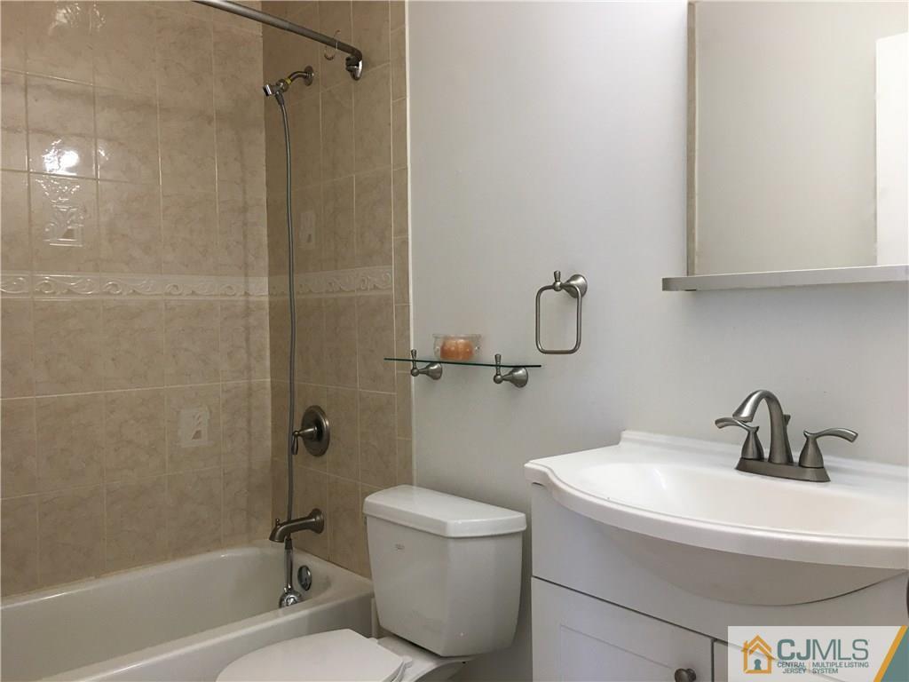 23 Raleigh Road Edison, NJ 08817 - Photo 18 of 19 a bathroom with a sink a toilet and shower