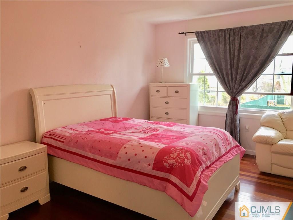23 Raleigh Road Edison, NJ 08817 - Photo 8 of 19 a bedroom with a bed and a window