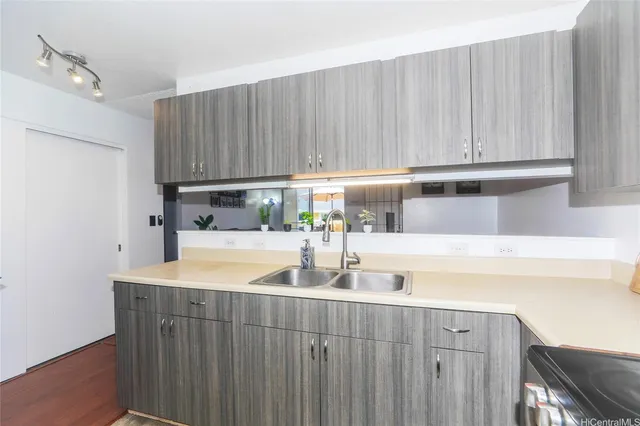 a kitchen with wooden cabinets a sink and a stove