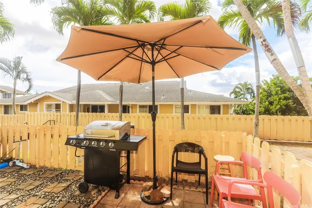 a view of an outdoor sitting area with brick walls