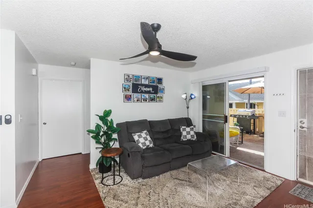 a living room with furniture and a ceiling fan