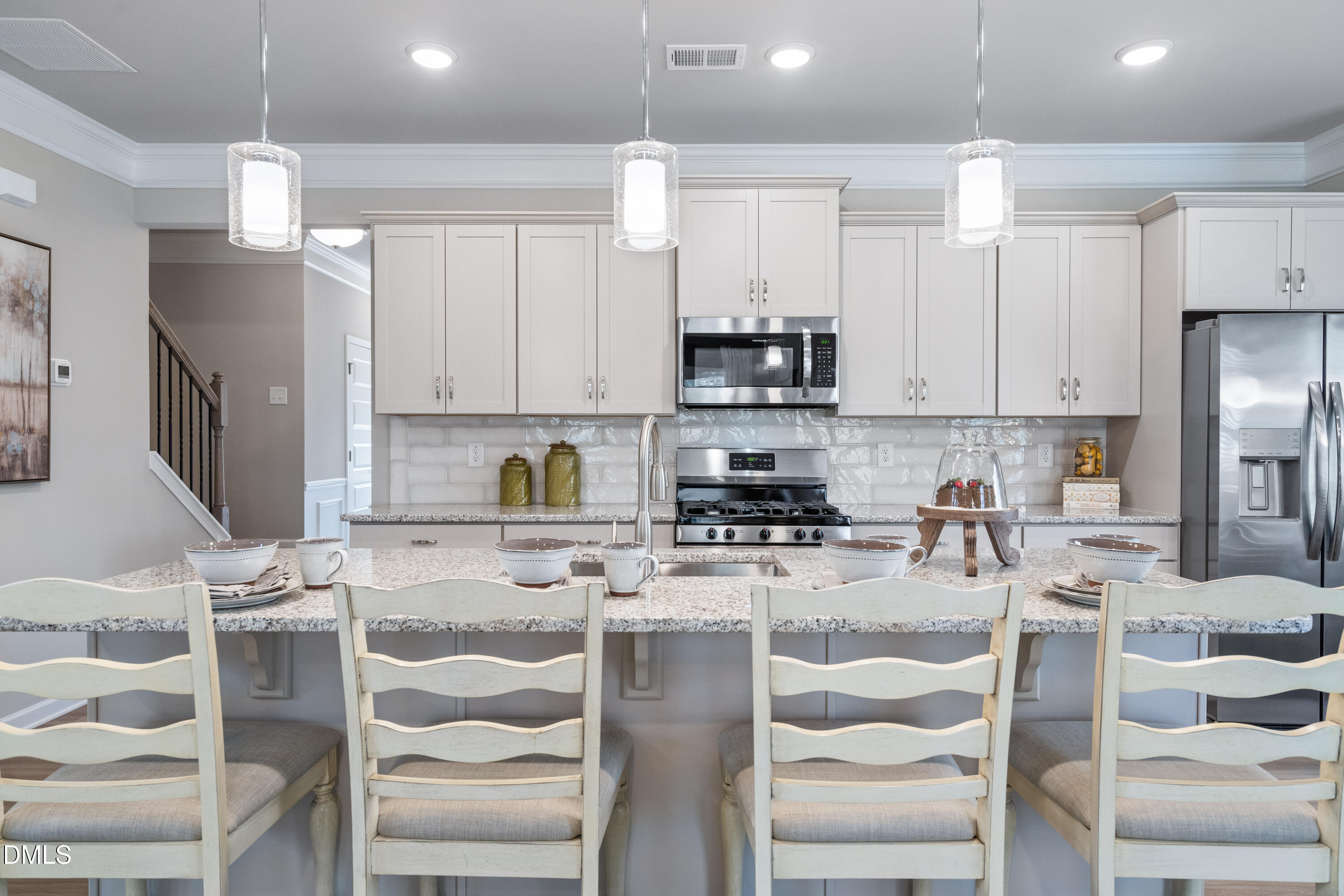 203 Courtside Drive Dunn, NC 28334 - Photo 11 of 38 a kitchen with stainless steel appliances kitchen island granite countertop a refrigerator and cabinets