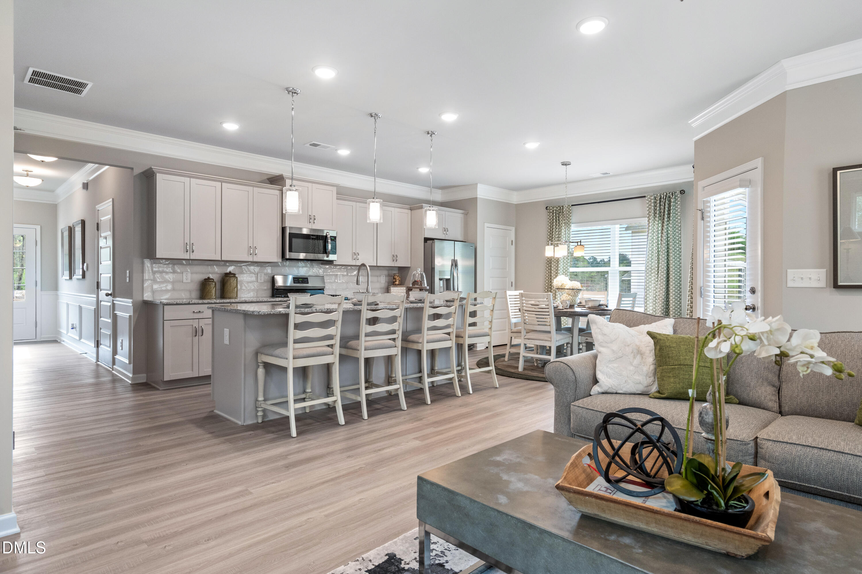 203 Courtside Drive Dunn, NC 28334 - Photo 17 of 38 a living room with stainless steel appliances furniture wooden floor and a kitchen view