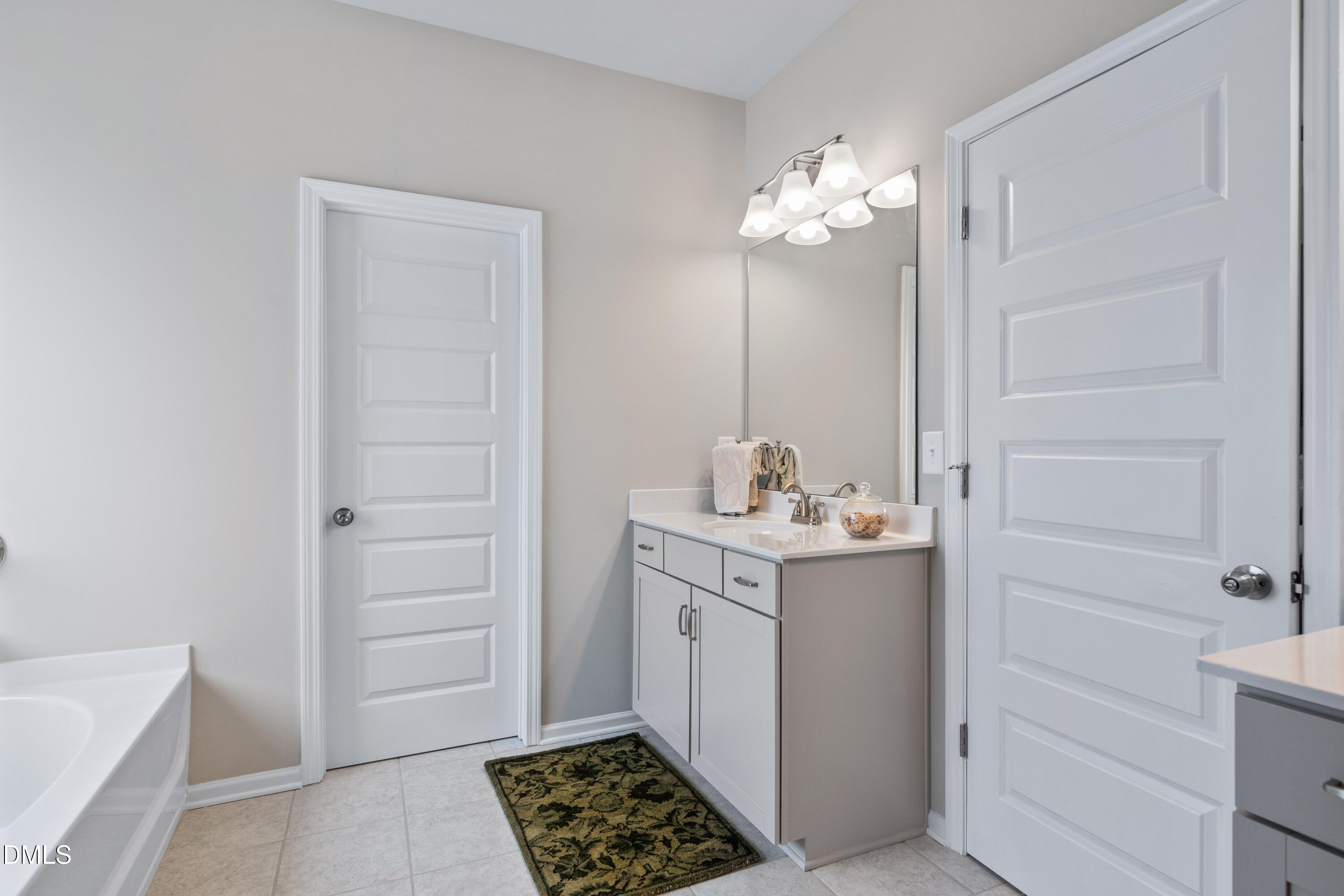 203 Courtside Drive Dunn, NC 28334 - Photo 30 of 38 a bathroom with a sink and a mirror