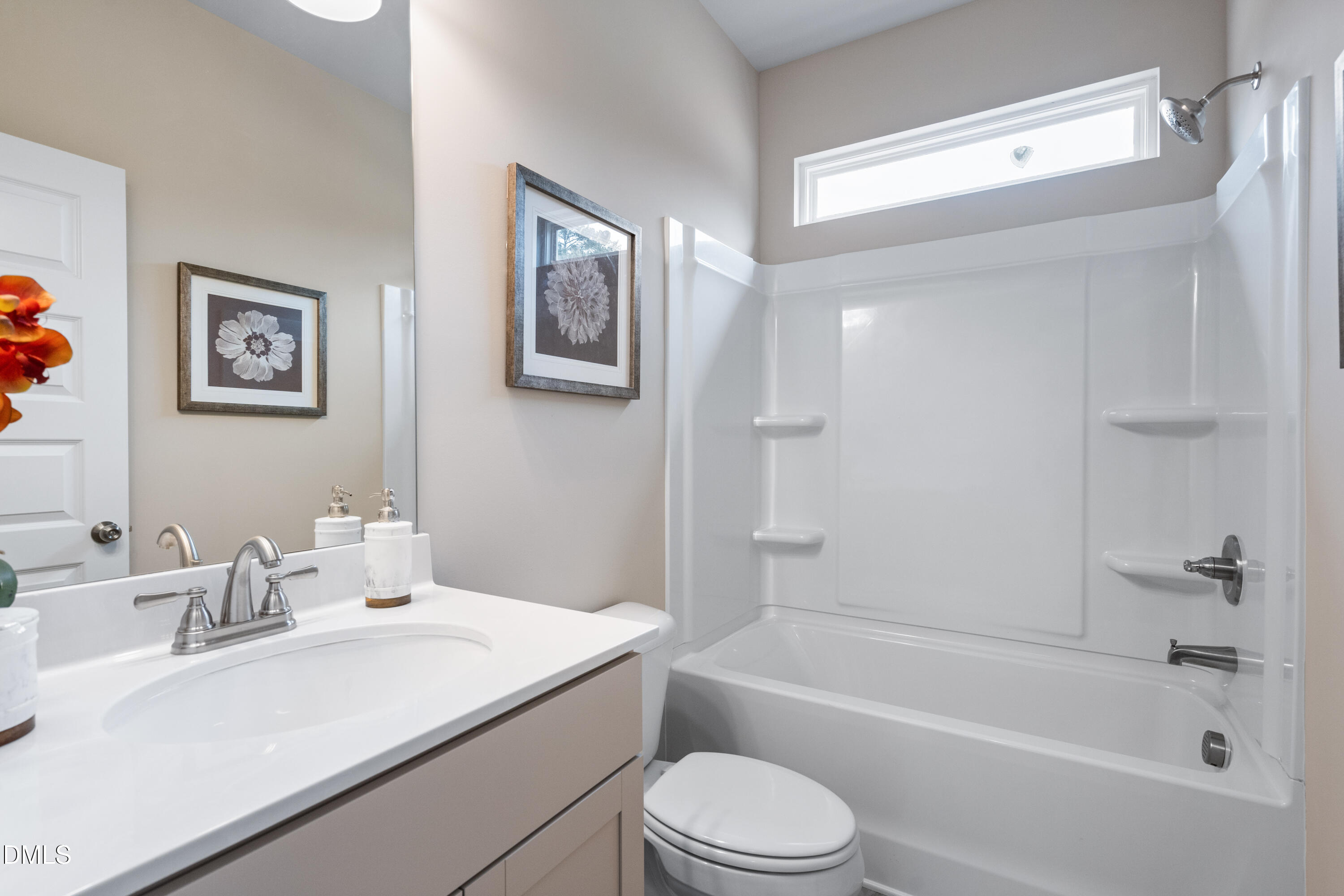 203 Courtside Drive Dunn, NC 28334 - Photo 34 of 38 a bathroom with a sink a toilet and bathtub