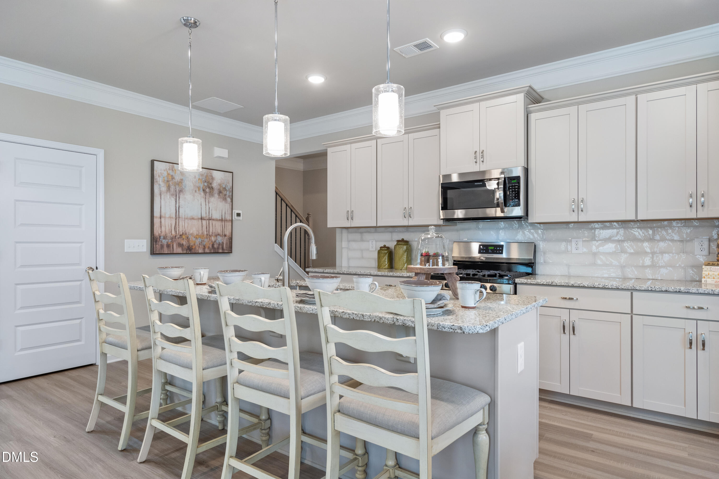 203 Courtside Drive Dunn, NC 28334 - Photo 10 of 38 a kitchen with white cabinets and stainless steel appliances