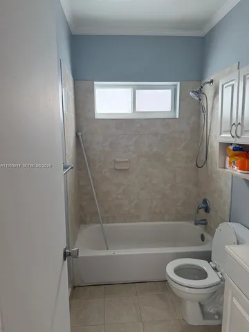 a bath room with a toilet and a bath tub