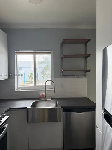 a kitchen with a sink and a window