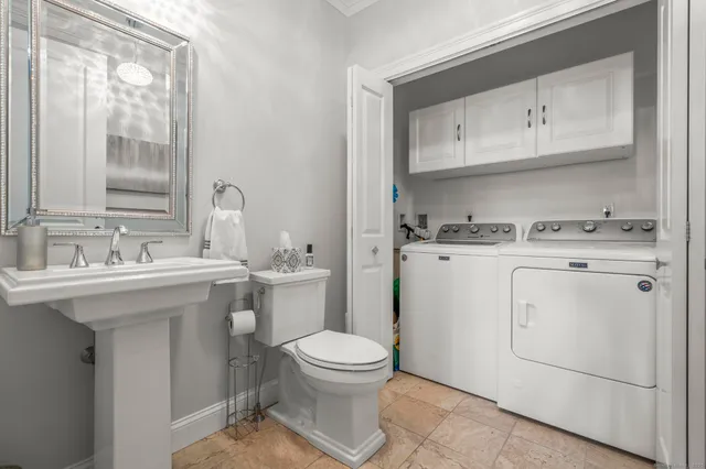 a bathroom with a sink toilet and mirror