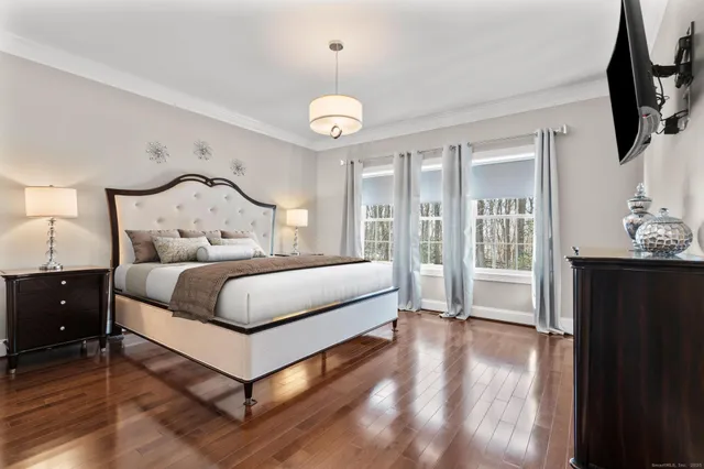 a spacious bedroom with a bed and a chandelier