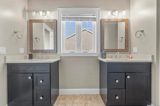 a bathroom with a sink vanity and mirror
