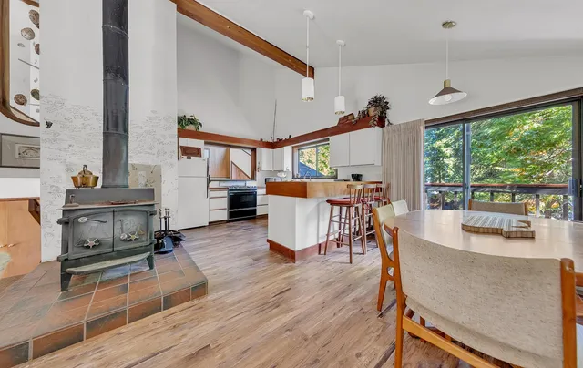 a living room with furniture a wooden floor and a large window