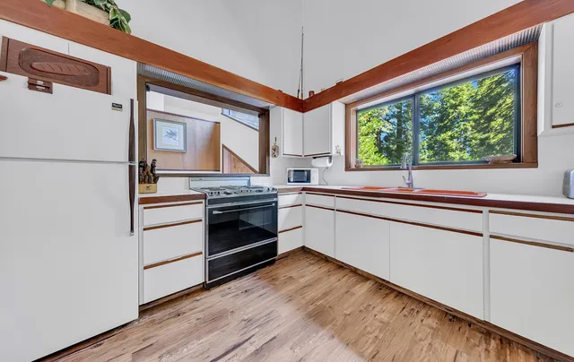 a kitchen with a stove and a white refrigerator