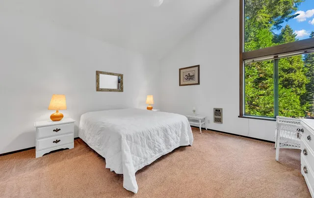 a bed room with a bed and a window