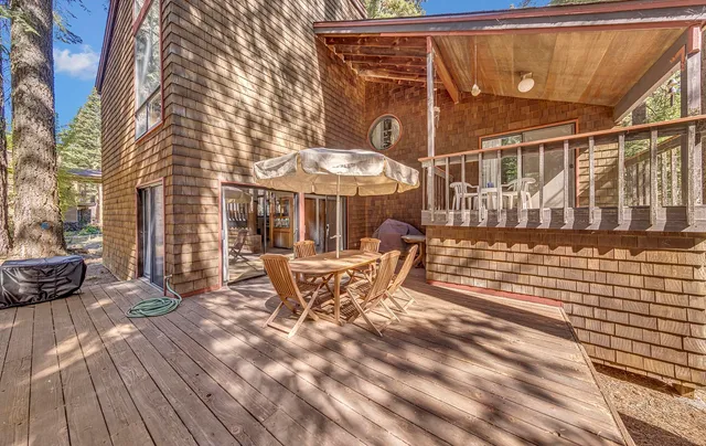 a view of a patio with a table and chairs