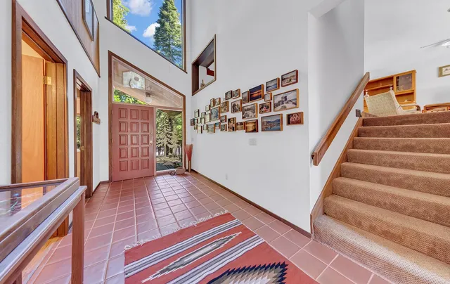 a view of an entryway with wooden floor and stairs