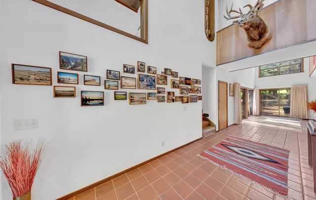 a view of a kitchen with fridge and wooden floor