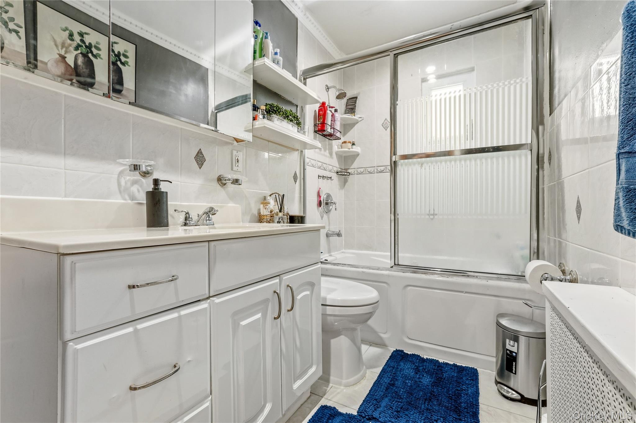 83-39 252nd Street Queens, NY 11426 - Photo 7 of 26 Bathroom with a white vanity featuring a light-toned countertop and chrome hardware