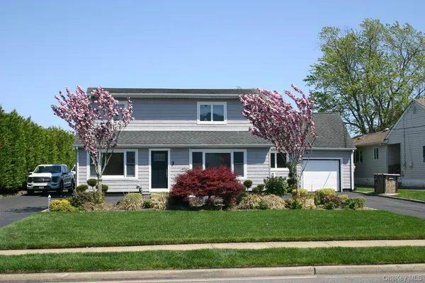 a front view of a house with a garden