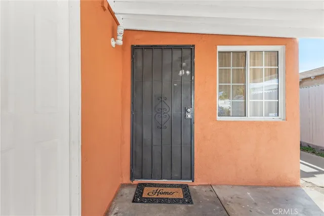 an empty room with windows and cabinet