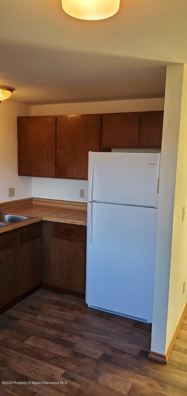 1012-1018 Stillwell Avenue Rifle, CO 81650 - Photo 15 of 15 a kitchen with a refrigerator and a microwave