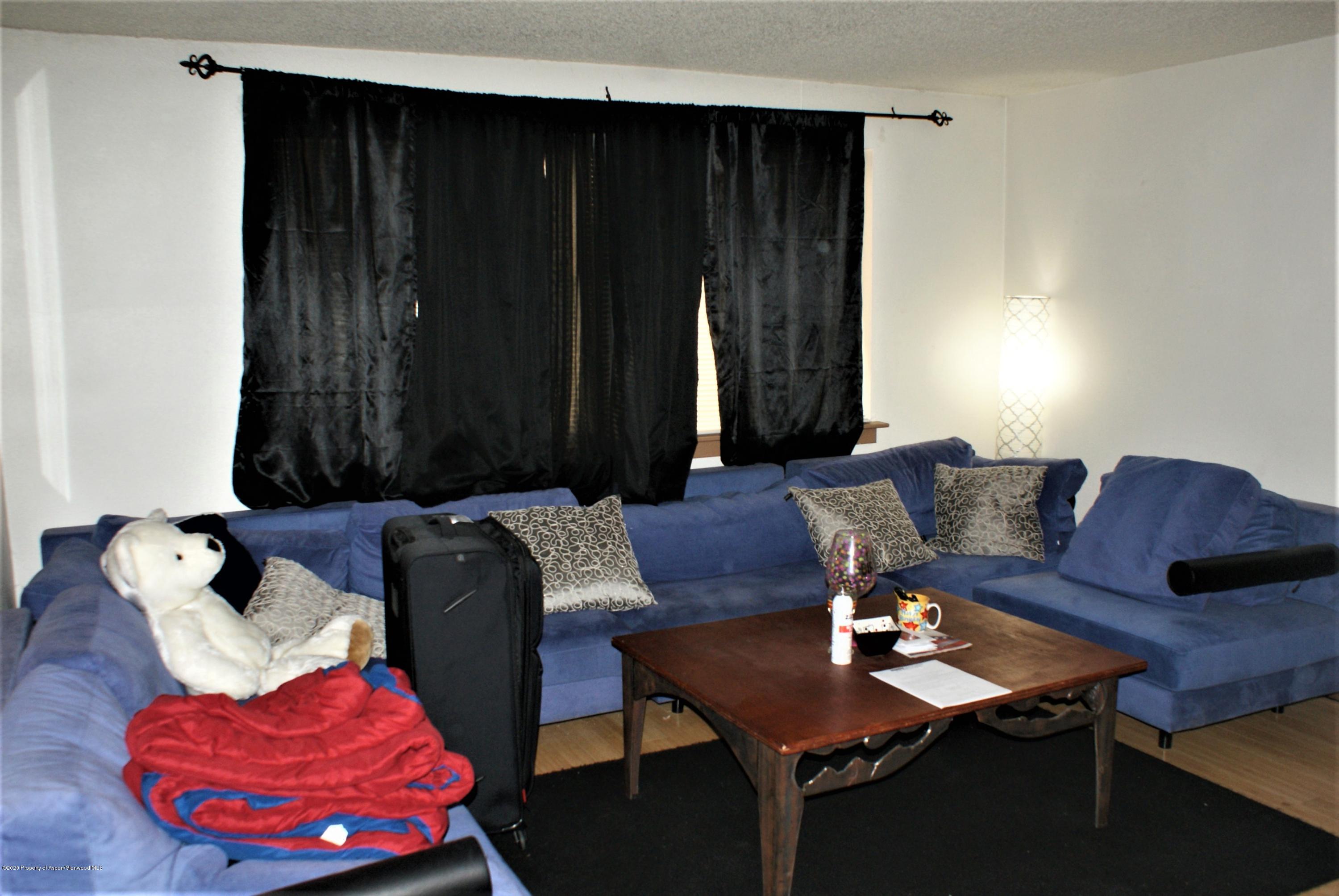 1012-1018 Stillwell Avenue Rifle, CO 81650 - Photo 4 of 15 a living room with furniture and a closet