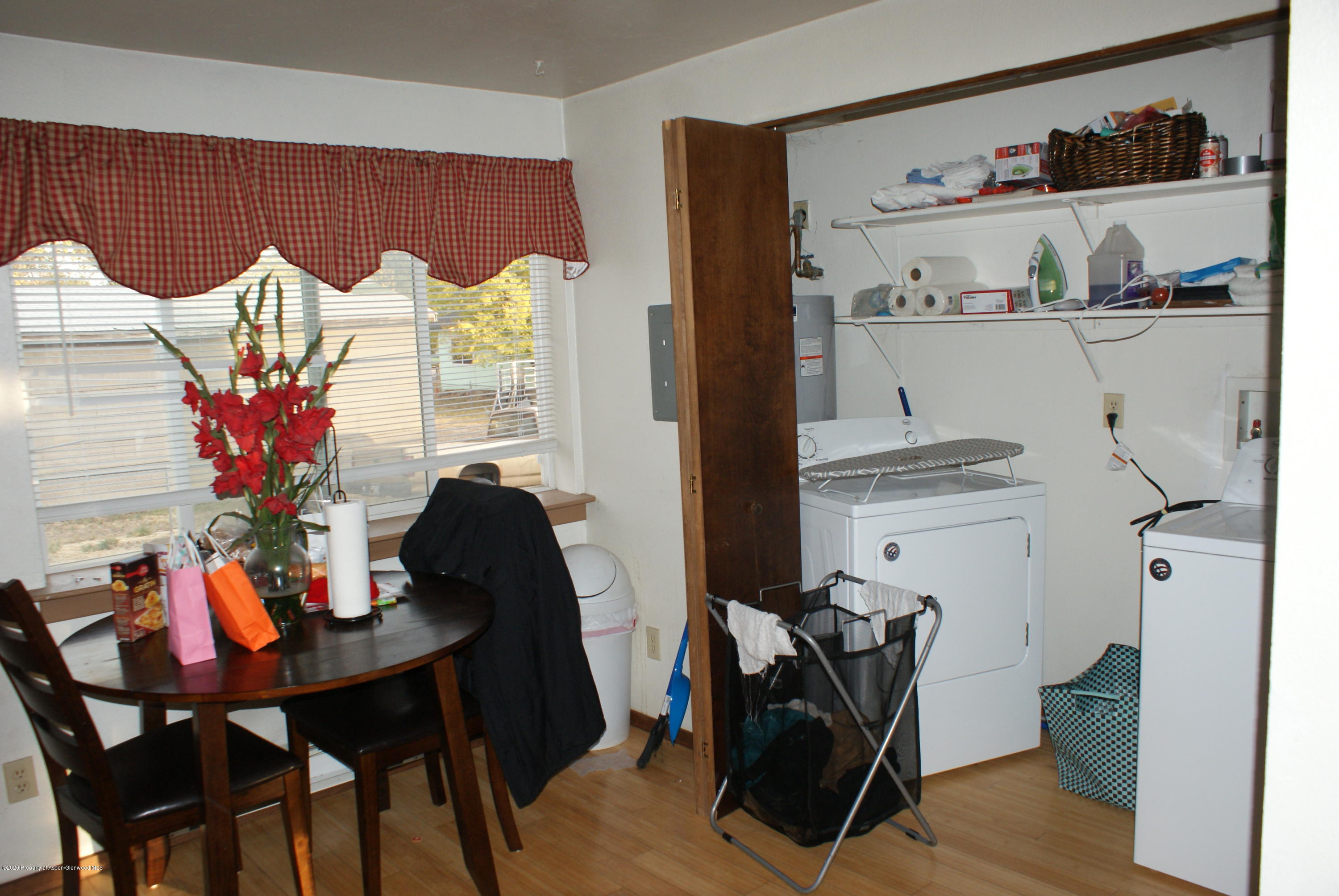 1012-1018 Stillwell Avenue Rifle, CO 81650 - Photo 7 of 15 a view of a dining room with furniture and wooden floor