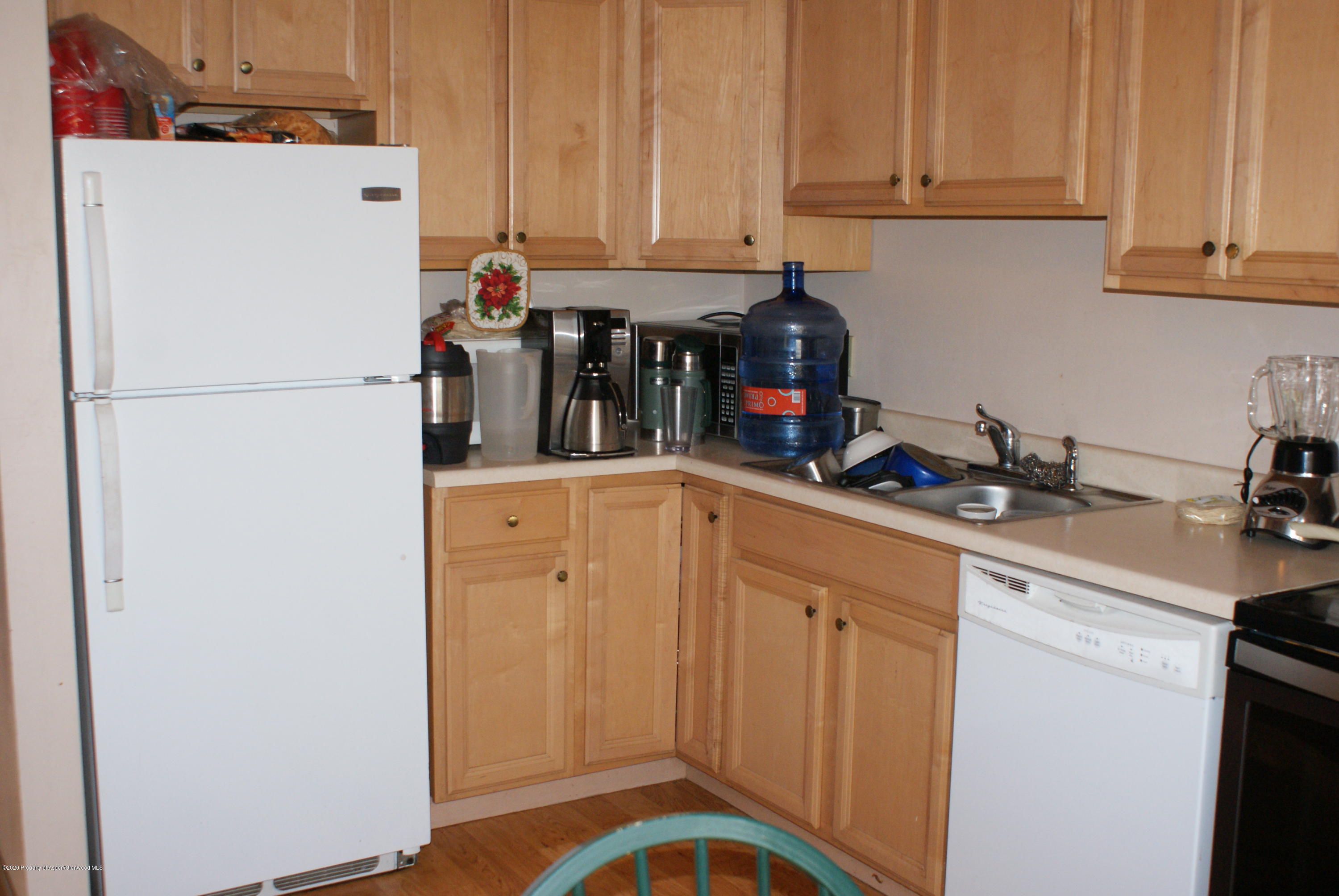 1012-1018 Stillwell Avenue Rifle, CO 81650 - Photo 8 of 15 a kitchen with refrigerator and cabinets