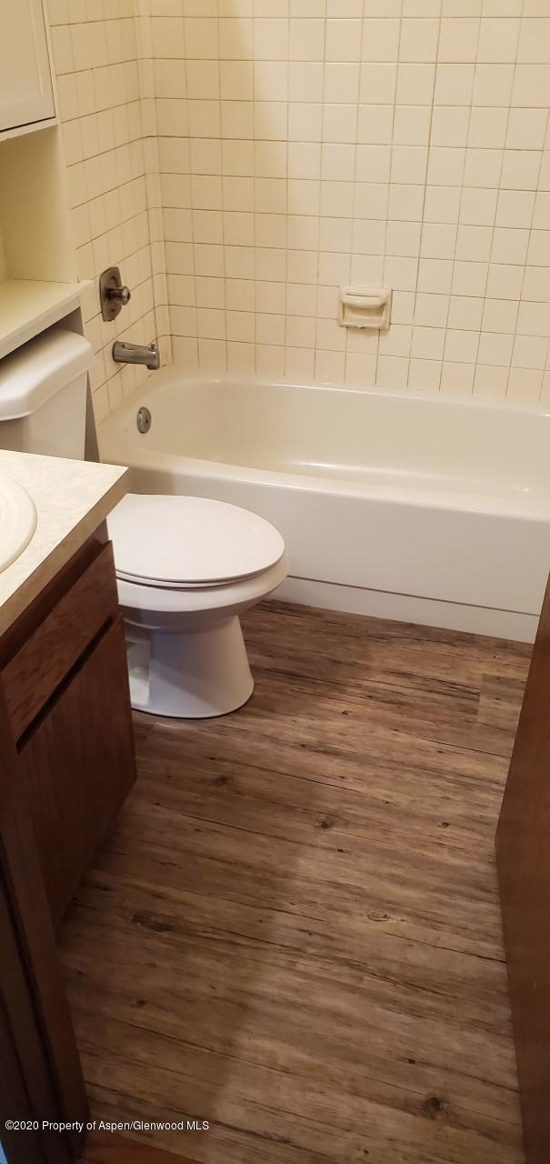 1012-1018 Stillwell Avenue Rifle, CO 81650 - Photo 9 of 15 a bathroom with a toilet and a bath tub