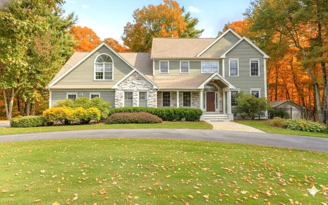 a front view of a house with a garden and porch