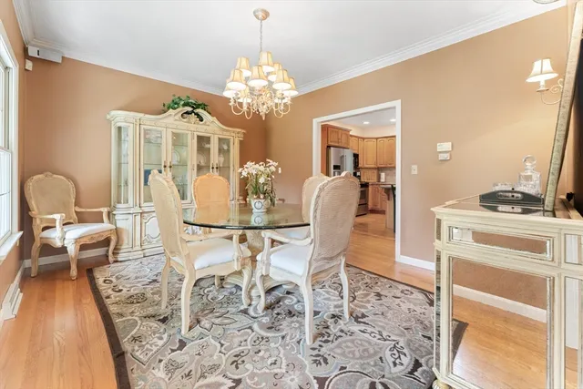 a dining room with furniture a rug a rug and a chandelier