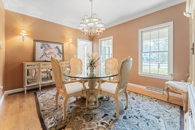 a dining room with wooden floor and breakfast area