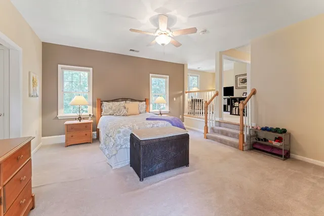 a spacious bedroom with a bed and a chandelier