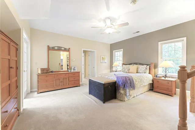 a spacious bedroom with a bed and a chandelier