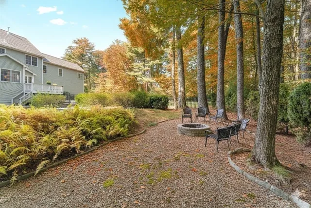 a view of a patio with table and chairs and wooden fence