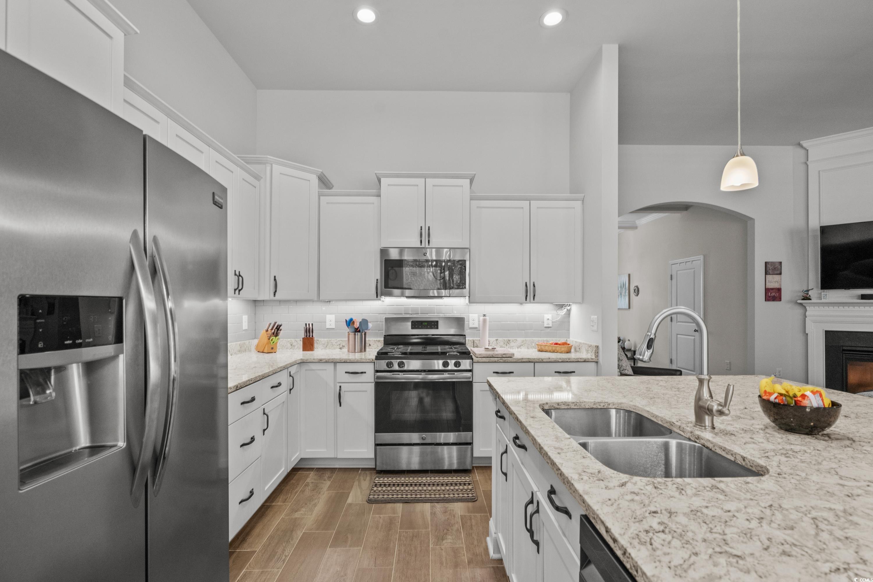 4284 Livorn Loop Myrtle Beach, SC 29579 - Photo 17 of 40 Kitchen featuring wood finish floors, arched walkw
