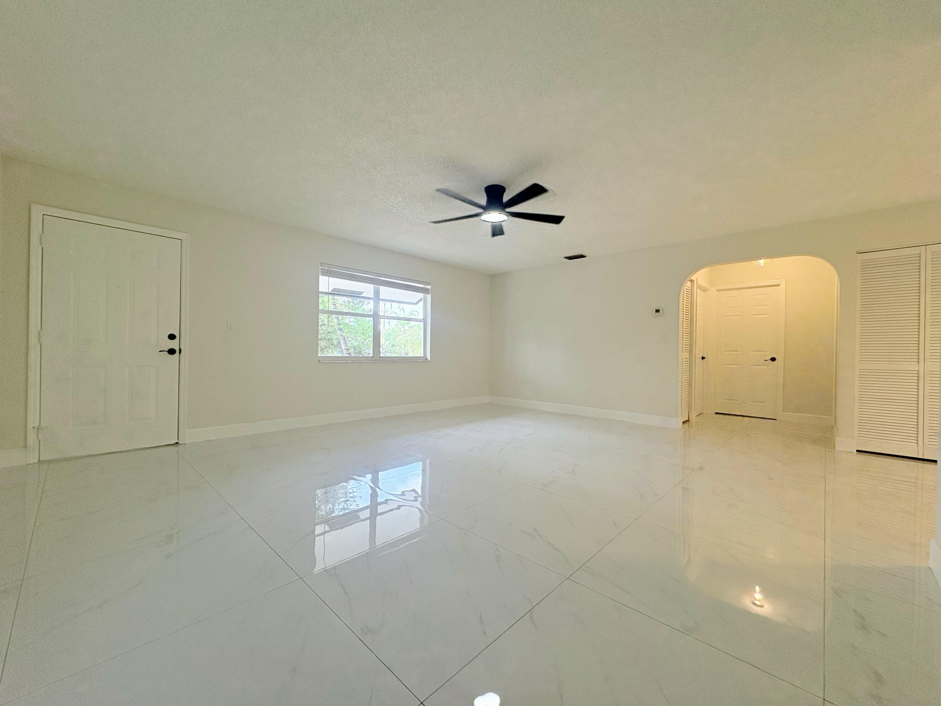 14523 Flamingo Road Loxahatchee Groves, FL 33470 - Photo 15 of 50 a view of a livingroom with a ceiling fan and window