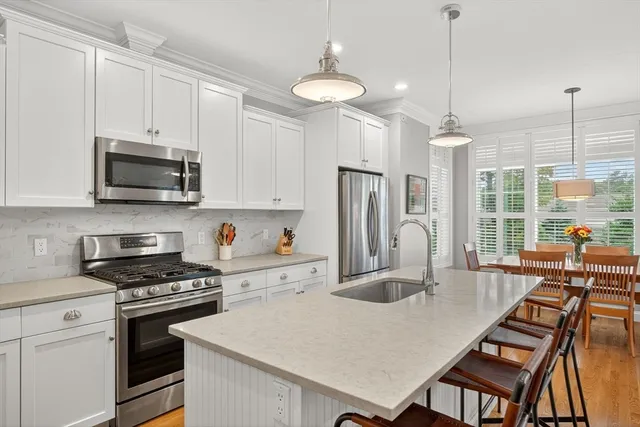 a kitchen with a stove a sink and a refrigerator