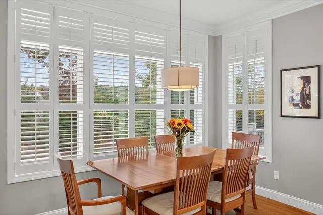 a dining room with furniture and wooden floor