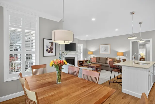 a living room with fireplace furniture and a chandelier