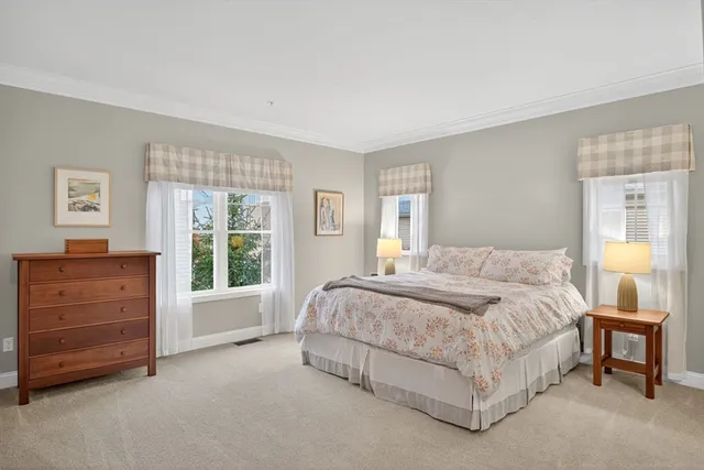 a spacious bedroom with a bed and a dresser