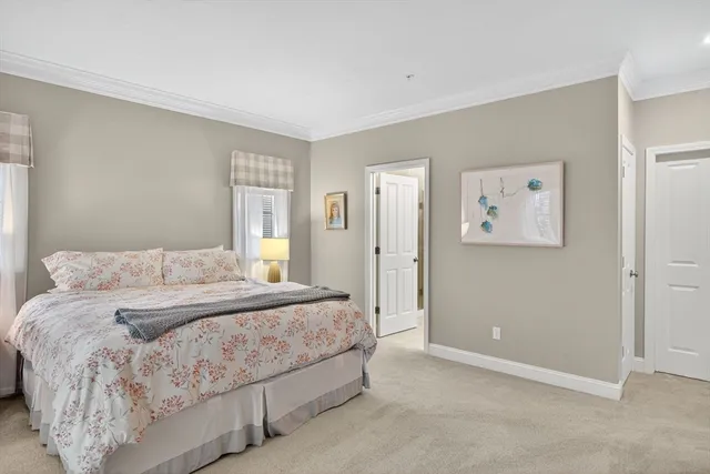 a bedroom with a bed and painting on the wall