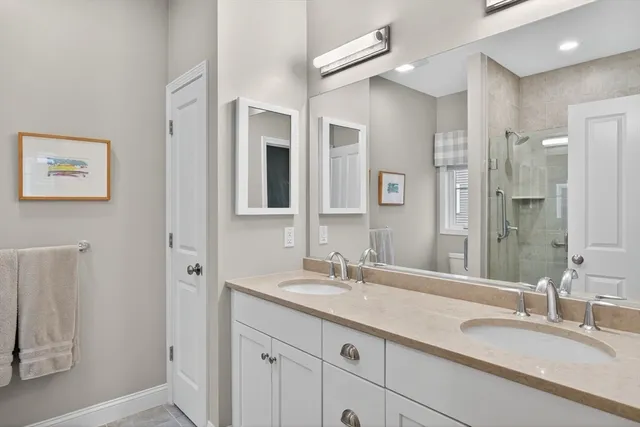 a bathroom with a granite countertop sink mirror and double