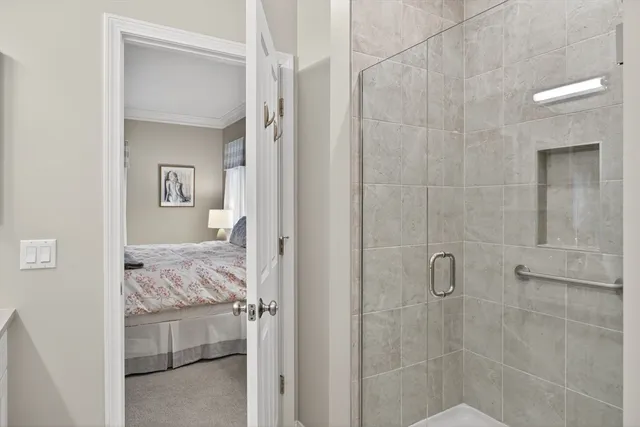 a bathroom with a granite countertop sink a toilet and shower