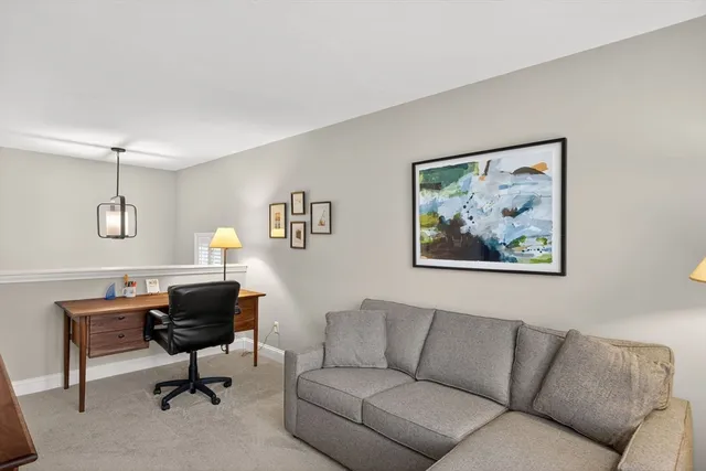 a view of a livingroom with workspace and a couch