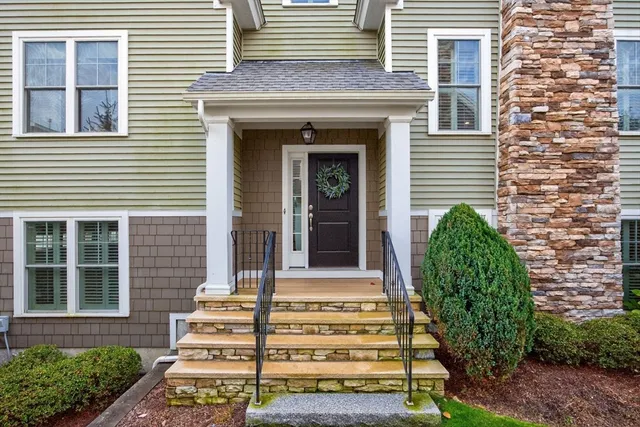 a front view of a house with a garden
