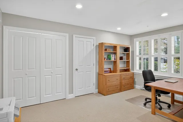 a livingroom with workspace and a window